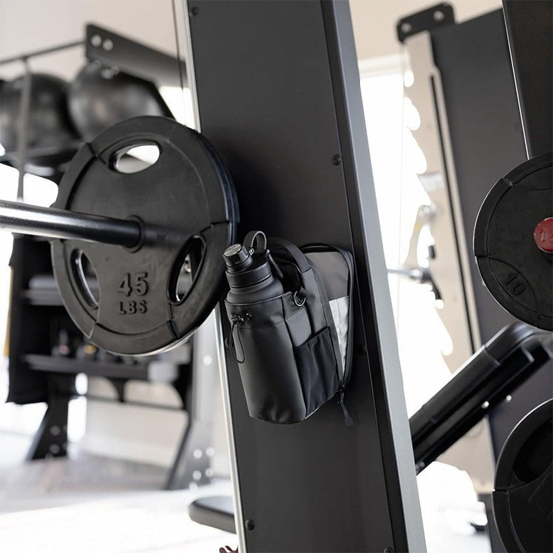 Magnetic gym bottle holder attached to gym equipment